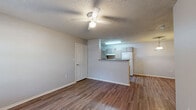 Located at 1018 South Birch Street in Sapulpa, Oklahoma, this single-story residence offers a thoughtfully organized layout encompassing one bedroom, one bathroom, a combined kitchen and living area. The living room features durable wood-look plank flooring, neutral gray walls, a ceiling fan with light fixture, and a window that allows natural light to fill the space. It opens conveniently toward the kitchen, creating a cohesive and functional common area. The kitchen is well-equipped with ample light wood cabinetry, a full suite of white appliances including a range, refrigerator, and dishwasher, a double-basin sink, and a breakfast bar peninsula that separates it from the living space. Light wood-look flooring continues throughout, and a pendant light adds a warm accent. The bedroom offers generous proportions with soft carpeting, a ceiling fan, a window with outdoor views, and direct access to additional storage. The bathroom is notably spacious and features accessibility-minded design, including stainless steel grab bars near the tub and toilet, wood-look flooring, a single-basin vanity with mirror, and a tub-shower combination. Textured ceilings are consistent throughout the residence, contributing to its classic character.