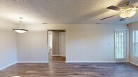 This 610 square foot apartment offers a well-designed living space on a single floor. The modern kitchen is equipped with light wood cabinetry, stainless steel appliances, and a practical breakfast bar with a dark countertop. The living area is spacious and inviting, featuring a fireplace for added warmth and ambiance. Large windows allow ample natural light and provide pleasant outdoor views.

The bedroom, measuring 150 square feet, includes a ceiling fan and connects to the bathroom. The bathroom is outfitted with a vanity, toilet, and a bathtub-shower combination. Throughout the apartment, updated wood-look flooring adds a contemporary touch and unifies the space.

The open floor plan maximizes the use of space, with the kitchen flowing seamlessly into the living area. Ceiling fans in main rooms offer comfort and air circulation. Two closets provide storage options. The apartment's neutral color palette and clean lines create a fresh, modern atmosphere suitable for various decorating styles.