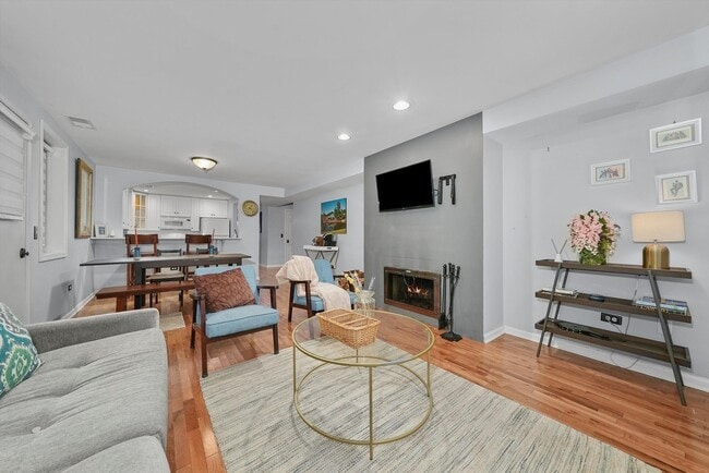 Living Room featuring custom shades & dual working gas & wood fireplace - 4212 N Ashland Ave