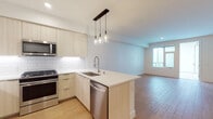 Located at 4499 Ohio St in San Diego's vibrant 92116 neighborhood, this modern single-floor residence showcases a thoughtfully designed open-concept layout with clean lines and contemporary finishes throughout. Light wood-tone flooring runs continuously across the living, dining, and kitchen areas, creating a warm and cohesive aesthetic.

The kitchen is a standout feature, equipped with full stainless steel appliances including a gas range, microwave, refrigerator, and dishwasher. Light wood flat-front cabinetry extends to the ceiling, complemented by white quartz countertops and a classic subway tile backsplash. A peninsula with a single-basin sink and industrial-style faucet provides additional prep space and separates the kitchen from the open living area. Pendant lighting with glass bulb fixtures adds a modern touch overhead.

The living area is generously proportioned, bathed in natural light from large windows that offer views to an outdoor space. Clean white walls and recessed lighting contribute to the bright, airy ambiance.

The bedroom is well-sized with a large window that brings in ample natural light. The bathroom features a dual-sink vanity with light wood cabinetry and white quartz countertops, a large mirror, and a full soaking tub with tiled surround and contemporary chrome fixtures. The consistent use of light wood flooring and neutral tones throughout ties the entire space together seamlessly.