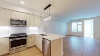 Located at 4499 Ohio St in San Diego's vibrant 92116 neighborhood, this modern single-floor residence showcases a thoughtfully designed open-concept layout with clean lines and contemporary finishes throughout. Light wood-tone flooring runs continuously across the living, dining, and kitchen areas, creating a warm and cohesive aesthetic.

The kitchen is a standout feature, equipped with full stainless steel appliances including a gas range, microwave, refrigerator, and dishwasher. Light wood flat-front cabinetry extends to the ceiling, complemented by white quartz countertops and a classic subway tile backsplash. A peninsula with a single-basin sink and industrial-style faucet provides additional prep space and separates the kitchen from the open living area. Pendant lighting with glass bulb fixtures adds a modern touch overhead.

The living area is generously proportioned, bathed in natural light from large windows that offer views to an outdoor space. Clean white walls and recessed lighting contribute to the bright, airy ambiance.

The bedroom is well-sized with a large window that brings in ample natural light. The bathroom features a dual-sink vanity with light wood cabinetry and white quartz countertops, a large mirror, and a full soaking tub with tiled surround and contemporary chrome fixtures. The consistent use of light wood flooring and neutral tones throughout ties the entire space together seamlessly.