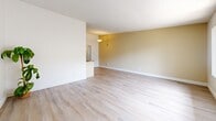 Located on Ocean Ave in Torrance, CA, this single-story, one-bedroom, one-bathroom unit offers a practical and well-organized layout. The open-concept living and dining area is finished with light hardwood-style flooring and neutral warm-toned walls, creating a bright and welcoming atmosphere. A large picture window with vertical blinds allows natural light to fill the space and provides views of the surrounding exterior. The galley-style kitchen features cream cabinetry, a mosaic tile backsplash, granite-style countertops, and a ceiling fan overhead, with a pass-through counter connecting it to the living area. Stainless steel and black appliances complete the functional cooking space. The bedroom is comfortably sized, featuring plush carpet flooring, a window with natural light and outdoor views, a textured ceiling, and a built-in sliding-door closet offering ample storage. The full bathroom is clean and modern, showcasing light hardwood-style flooring, a sliding-glass enclosed tub and shower, a wall-mounted vanity with mirror, and a bright window that enhances the airy feel. A hallway connects the rooms, providing a smooth flow throughout the unit. Overall, the space presents a cohesive, light-filled, and functional living environment.