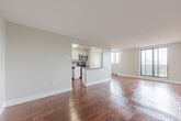 This well-appointed 3-bedroom, 1-bathroom unit at 400 Parkside Dr in Waterloo, Ontario offers a functional and comfortable layout across a single floor. Rich hardwood flooring flows throughout the entire space, lending warmth and continuity to each room.

The open living area is bright and welcoming, featuring large windows and a sliding glass door that fill the space with natural light and provide views of the surrounding greenery. A baseboard heating system runs along the exterior walls, ensuring year-round comfort.

The galley-style kitchen is efficiently designed with white cabinetry, grey countertops, a classic tile backsplash, and stainless steel appliances including a refrigerator, stove, and built-in microwave. Ample counter and storage space make this kitchen highly practical.

Each of the three bedrooms is finished with the same warm hardwood flooring and neutral grey walls. The bedrooms are served by windows that frame pleasant outdoor views of the surrounding neighbourhood and trees. The primary bedroom offers a comfortable footprint with dedicated closet storage nearby.

The bathroom is clean and modern, featuring white cabinetry, a grey countertop vanity, a well-lit mirror, and tile flooring. The overall aesthetic of this unit is neutral and move-in ready, making it a practical and comfortable home in a residential Waterloo neighbourhood.