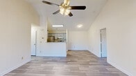 Located at 793 Patriot Pkwy in Rock Hill, SC, this 2-bedroom, 2-bathroom single-floor home offers a well-designed layout with a bright, open feel. The living room is a standout space, boasting vaulted ceilings, a ceiling fan with light kit, and French doors that invite natural light while providing outdoor access. Wood-look plank flooring runs throughout the main living areas, adding a clean, contemporary aesthetic.

The kitchen is seamlessly integrated into the open-concept living area via a peninsula with granite-style countertops. It features gray cabinetry, stainless steel appliances including a refrigerator and range, tile backsplash, and a skylight that brightens the space naturally.

Both bedrooms are carpeted for comfort. The primary bedroom includes vaulted ceilings, a ceiling fan, large windows, and a spacious walk-in closet with wire shelving. The second bedroom features plush carpet and a window with natural light. Each bathroom is finished with wood-look tile flooring, gray vanities with granite-style countertops, and a tub/shower combination. A dedicated laundry area with washer and dryer hookups completes this thoughtfully arranged home.