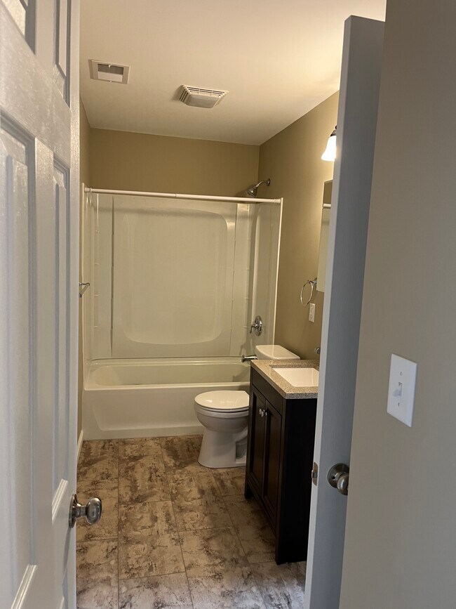 Full Bathroom attaches to Bedroom 1 and opens to Hallway - 208 Hackberry Dr