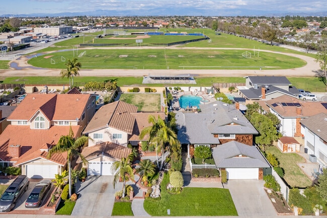 The residential scene is right next door to local schools and sports fields.