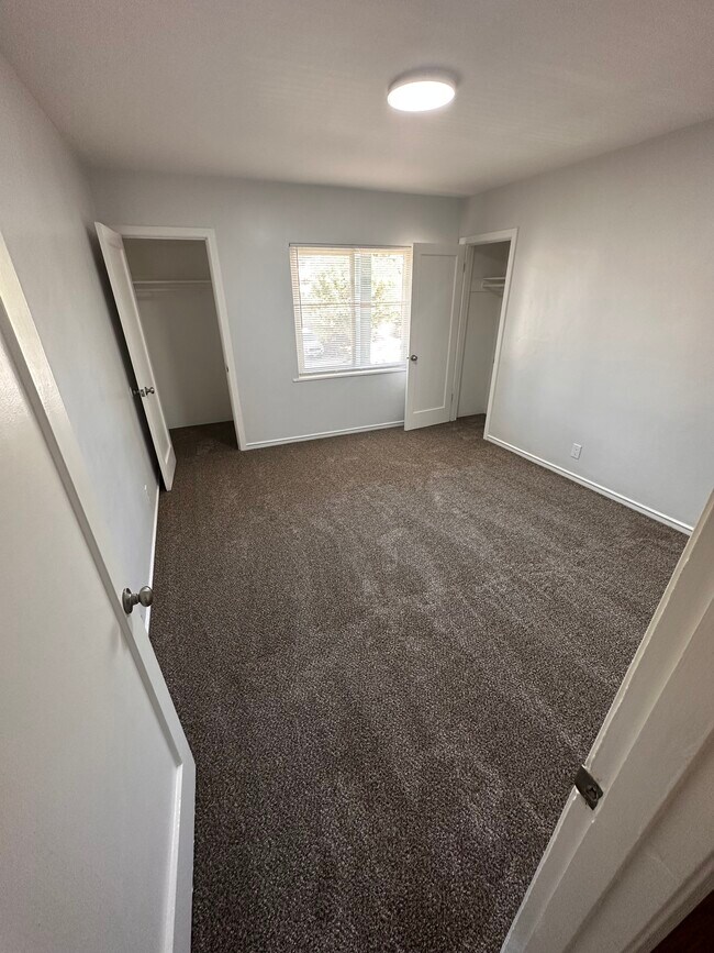Bedroom #1 updated with fresh paint and new carpet, featuring two mid-sized closets - 6333 MacArthur Blvd