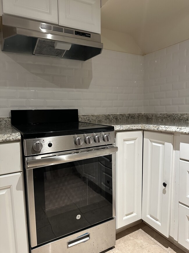 Stainless steel stove with hood - 62 E Centennial Ave