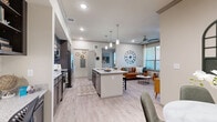 Located at 2906 Delafield St in Houston, TX, this thoughtfully designed 2-bedroom, 2-bathroom residence offers a functional and modern single-floor layout. The open-concept living and kitchen area serves as the heart of the home, featuring light wood-style flooring, recessed lighting, and a ceiling fan that enhances airflow and comfort. The kitchen is well-appointed with dark shaker-style cabinetry, granite countertops, a classic white subway tile backsplash, stainless steel appliances, and a spacious center island with bar seating — ideal for both cooking and casual dining. The living area benefits from natural light streaming through blinds-fitted windows. The primary bedroom is a comfortable retreat with large windows, access to a walk-in closet with built-in shelving and hanging rods, and an en-suite bathroom featuring a double-sink vanity with granite countertops and a walk-in shower. The second bathroom includes a granite vanity and a tub-shower combination with tile surround. Both bedrooms include closet storage. An in-unit laundry area with washer and dryer hookups adds everyday convenience. The entryway offers a welcoming transition into the home with access to natural light via a sidelight window.