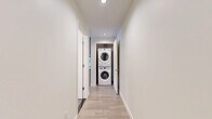 Located in the heart of Downtown Los Angeles, this modern 1-bedroom, 1-bathroom residence at 1133 S Hope St offers a well-designed layout with contemporary finishes throughout. Light wood-tone flooring runs continuously across the space, complementing the clean, neutral color palette.

The open-concept kitchen and living area serves as the central hub of the home. The kitchen is outfitted with sleek gray flat-front cabinetry extending to the ceiling, a light-blue subway tile backsplash, white quartz countertops, and a full suite of stainless steel appliances including a gas range, built-in microwave, dishwasher, and French door refrigerator. In-unit washer and dryer are also included.

The living area benefits from floor-to-ceiling windows and a glass door that frame sweeping urban views of the Downtown LA skyline, flooding the space with natural light. The bedroom is generously proportioned, featuring a large walk-in closet and an expansive window with city views. The bathroom is finished with large-format gray floor tiles, a full soaking tub with shower combination, and crisp white wall surrounds. A connecting hallway ties all areas together efficiently, maximizing the functional use of the overall footprint.