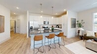 Located at 116 Two Creek Way in Candler, NC, this thoughtfully designed single-floor home offers three bedrooms, three bathrooms, and a functional layout ideal for comfortable everyday living. Light hardwood-style flooring flows throughout the main areas, complemented by crisp white walls and recessed lighting that create a clean, modern aesthetic.

The kitchen is a standout feature, showcasing tall white shaker cabinetry, dark granite countertops, a subway tile backsplash, and stainless steel appliances. A curved center island with seating for three provides additional prep space and serves as a natural gathering point open to the living area. The living room benefits from a large window that allows ample natural light to fill the space.

Each bedroom offers carpeted flooring and dedicated closet space, including a generously sized walk-in closet with wire shelving in the primary suite. The three bathrooms are finished with white cabinetry and dark granite countertops, with at least one featuring a full tub-shower combination. A dedicated laundry room houses a full-size front-loading washer and dryer with overhead shelving for added storage convenience. Overall, the home presents a cohesive, modern interior with practical amenities throughout.