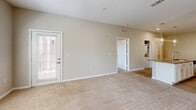 Located at 1533 Ellis Rd in Durham, NC, this well-appointed two-bedroom, two-bathroom residence offers thoughtfully designed single-floor living. The open-concept layout connects the kitchen, dining, and living areas into one cohesive, light-filled space. The kitchen is a standout feature, showcasing granite countertops, a large center island with a built-in sink, white shaker cabinetry, a classic subway tile backsplash, stainless steel appliances, and elegant pendant lighting. Wood-look flooring runs throughout the main living areas, while plush carpeting adds warmth to the bedrooms and living room. The spacious primary bedroom includes a ceiling fan, a walk-in closet with built-in shelving, and a private en-suite bathroom featuring granite countertops, white cabinetry, and a glass-enclosed standing shower. The second bedroom is bright and well-proportioned, with natural light from large windows and its own ceiling fan. A dedicated utility room, three closets, and a hallway provide ample storage. A private balcony extends the living space outdoors. Neutral tones throughout the interior create a clean, versatile aesthetic suited to a variety of furnishing styles.