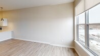 Located at 900 3rd St SE in Cedar Rapids, Iowa, this thoughtfully designed one-bedroom, one-bathroom unit offers a clean, modern aesthetic throughout its efficiently utilized single-floor layout. Light-toned walls, white trim, and durable wood-look flooring create a cohesive and contemporary feel across the main living areas.

The open-concept kitchen and living room serve as the heart of the unit. The kitchen is outfitted with crisp white shaker-style cabinetry, light quartz countertops, a full suite of stainless steel appliances — including a refrigerator, range, built-in microwave, and dishwasher — and a peninsula with an undermount sink illuminated by stylish gold pendant lights. This space flows naturally into the living area, creating an inviting, functional environment.

The bedroom features plush carpeting, a ceiling fan, and a large window offering neighborhood views, allowing ample natural light to fill the room. Adjacent to the bedroom is a dedicated laundry area with a stacked Samsung washer and dryer unit alongside wire shelving for additional storage.

The bathroom is finished with wood-look flooring, a white vanity with a bright mirror, and a full tub-shower combination. Clean lines and neutral tones carry throughout, contributing to the unit's bright and move-in-ready appeal.