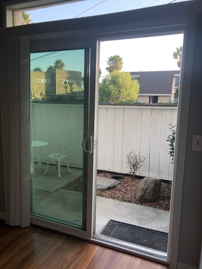 Front patio (1of 2) is enclosed and accessible from the dining area. - 3881 Groton St