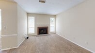Located at 6300 Moseley Dixon Rd in Macon, Georgia, this single-story, 2-bedroom, 1-bathroom home offers a comfortable and functional layout. The living room serves as the heart of the home, anchored by a classic brick fireplace flanked by two tall windows that flood the carpeted space with natural light, creating a warm and inviting atmosphere. The kitchen features white cabinetry with decorative paneling, light wood countertops, durable wood-look flooring, and black appliances including a range, microwave, and refrigerator — a practical and clean setup for everyday cooking. A pantry provides additional storage to keep the kitchen organized. The primary bedroom is generously sized and includes a ceiling fan, two windows for ample natural light, and direct access to a dedicated walk-in closet with built-in shelving and hanging rods. The second bedroom also features carpet flooring, a ceiling fan, and a sliding glass door with vertical blinds leading to an outdoor area, offering greenery views. The full bathroom is efficiently appointed with a tub/shower combo and wood-look flooring. A dedicated closet adds to the home's overall storage. The single-floor layout ensures easy accessibility throughout, making this a well-rounded and practical residence.