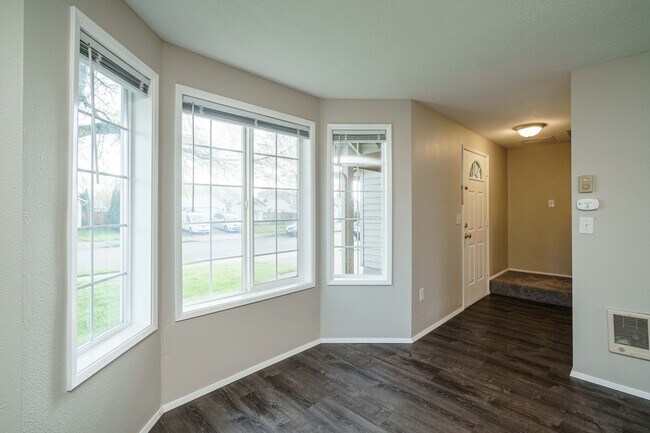 Building Photo - Recently Updated with Wood Laminate Flooring and Fresh Paint