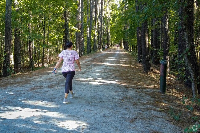 Some residents enjoy a walk in the woods on one of the trails in Outer Chapel Hill.