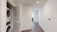 Located at 1120 W 6th St in the heart of Los Angeles, this 3-bedroom, 2-bathroom unit offers a well-designed single-floor layout with modern finishes throughout. The open-concept kitchen and living area serves as the centerpiece of the home, featuring a sleek kitchen with gray shaker cabinetry, a striking blue subway tile backsplash, stainless steel appliances including a gas range, microwave, dishwasher, and refrigerator, and a curved quartz countertop island with pendant lighting above. The living area is bathed in natural light from large windows offering views of the Downtown Los Angeles skyline, complemented by durable wood-look flooring. A hallway connects the bedrooms, which feature plush carpeting and bright white walls. The primary bedroom includes direct access to an en-suite bathroom. Both bathrooms are clean and functional, each outfitted with a full bathtub and shower combination, wood-look tile flooring, and gray vanity cabinetry with white countertops. Two closets provide ample storage throughout the unit. Recessed lighting and louvered closet doors add thoughtful detail, while the overall aesthetic remains crisp, contemporary, and move-in ready.