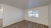 Located at 1612 Village East Dr in Denton, Texas, this single-story, 3-bedroom, 2-bathroom home offers a well-organized and efficiently designed floor plan. Wood-look plank flooring runs consistently throughout the entire home, lending warmth and visual continuity to every room.

The living room provides an open, versatile space with clean white walls, updated flooring, and easy access to the rest of the home. A hallway connects the living area to the bedrooms and bathrooms, keeping the layout practical and straightforward.

Each of the three bedrooms features the same wood-look flooring, bright white walls, and windows that allow natural light to fill the rooms. The spacious primary bedroom includes a ceiling fan with light fixture and closet access. The additional bedrooms are well-proportioned, each with windows offering views of the surrounding neighborhood.

The two bathrooms are finished in a clean, neutral palette. One bathroom features a tub/shower combination with white tile surround, chrome fixtures, and a vanity with granite-style countertops and white cabinetry, complemented by built-in storage.

The home's consistent, updated finishes and bright, neutral tones throughout create a clean and welcoming atmosphere, making this Denton property a practical and comfortable residence.