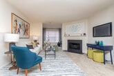 This single-story residence in Duluth, Georgia offers a well-organized layout with a variety of functional living spaces. The living room serves as the centerpiece of the home, featuring a classic fireplace with a white mantel surround, neutral-toned carpet, a textured ceiling, and a window that allows natural light to fill the room. An adjacent dining area accommodates a round table and provides a dedicated space for meals.

The kitchen is efficiently designed with an L-shaped layout, offering white cabinetry that extends to the upper walls for ample storage, white countertops, wood-look flooring, and black appliances including an electric range and dishwasher. A dedicated laundry room houses a full-sized washer and dryer alongside overhead wire shelving for added storage convenience.

The bedrooms are carpeted and well-lit, each featuring windows with blinds that allow adjustable natural light. The bathrooms include a tub-shower combination, vanity with counter space, and wood-look flooring. Throughout the home, neutral wall tones create a cohesive and versatile aesthetic, making each room adaptable to a variety of furnishing styles.