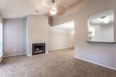 Located at 1310 Wood Bend Dr in Stone Mountain, GA, this two-floor home offers a well-organized layout designed for comfortable everyday living. The main living area is generously proportioned, featuring plush wall-to-wall carpeting, a textured ceiling, and multiple windows alongside a sliding glass door fitted with vertical blinds that flood the space with natural light and provide outdoor access. A charming fireplace with a tile surround serves as a focal point, adding warmth and character to the room.

The kitchen is efficiently designed with white cabinetry, dark countertops, a tile backsplash, black appliances including a range and refrigerator, and wood-style flooring. A pass-through window connects the kitchen directly to the adjacent living or dining area, creating an open and communicative flow between spaces.

The dining area is highlighted by a pendant light fixture and an open railing that overlooks the staircase, reinforcing the home's two-floor connectivity. Bedrooms are carpeted and well-lit, with windows offering views of the surrounding neighborhood. Neutral gray tones are carried throughout the home, lending a cohesive and move-in ready aesthetic. The overall layout balances functionality with comfortable, everyday livability.