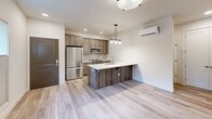 Located at 15948 Quarry Rd in Lake Oswego, Oregon, this thoughtfully designed two-bedroom, one-bathroom unit offers a modern and efficient layout across a single floor. Light-toned wood-look flooring runs throughout the entire unit, creating a cohesive and clean aesthetic from room to room.

The kitchen serves as the heart of the unit and is equipped with stainless steel appliances, including a full-size refrigerator, microwave, and range. Warm-toned cabinetry is complemented by a subway tile backsplash and a peninsula with a white quartz countertop, an undermount sink, and a pendant light above — ideal for both meal prep and casual dining. A ductless mini-split unit provides efficient climate control.

The open hallway connects the living areas to the two bedrooms, each featuring windows that invite natural light and views of surrounding greenery. The primary bedroom includes a sliding double-door closet and a wall-mounted mini-split unit for individual climate control. The second bedroom is similarly bright with a large window.

The bathroom is finished with clean, white subway tile in the tub/shower surround, wood-look flooring, and a vanity with a light countertop. The overall design of the unit is modern and move-in ready, with neutral tones and quality finishes throughout.