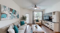 Located in Clermont, FL, this well-appointed 2-bedroom, 2-bathroom single-story residence offers a thoughtfully designed open-concept layout. The combined living, dining, and kitchen area forms the heart of the home, anchored by rich hardwood-style flooring throughout. The kitchen features dark espresso cabinetry, granite countertops, a breakfast bar, and white appliances, flowing seamlessly into the dining space and living room. The living room is bright and welcoming, with multiple windows allowing generous natural light, a ceiling fan, and direct access to the patio. The primary bedroom offers plush carpeting, a ceiling fan, natural light from a window, and access to a walk-in closet. The bathrooms are finished with granite-topped dark wood vanities and tile flooring; one bathroom includes a full soaking tub with tile surround. Additional highlights include a den, a dedicated laundry area, five closets for ample storage, and a private patio. The neutral color palette and clean architectural lines create a cohesive, airy ambiance throughout the residence.