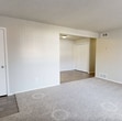 This single-story residence offers a practical and efficient layout within its 940 square feet of living space. The home boasts four bedrooms, including a spacious primary bedroom measuring 210 square feet, providing ample space for relaxation and storage. Two full bathrooms cater to the needs of residents and guests alike.

The kitchen is a highlight, featuring white cabinetry, light-colored countertops, and a suite of appliances including a dishwasher, range, and refrigerator. The galley-style layout maximizes efficiency while providing sufficient counter space for meal preparation.

Throughout the home, a combination of flooring types creates visual interest. Bedrooms are carpeted in a neutral tone, promoting comfort and warmth, while the kitchen and bathroom areas feature durable wood-look flooring. The living room showcases a transition between these two flooring styles, adding a touch of design flair.

Large windows in the bedrooms and living areas allow natural light to flood the space, creating a bright and airy atmosphere. The bathrooms are outfitted with modern fixtures, including a bathtub in at least one of the facilities.

The overall design aesthetic is clean and contemporary, with neutral wall colors and simple, functional fixtures. This property offers a comfortable living environment suitable for a variety of household configurations.