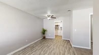 Located at 5327 Timuquana Rd in Jacksonville, Florida, this one-bedroom, two-bathroom unit offers a thoughtfully organized single-floor layout that maximizes every square foot. The living area greets you with durable wood-look vinyl flooring, neutral gray walls, a textured ceiling, and a ceiling fan that keeps the space comfortable year-round. Natural light filters in through slatted blinds on multiple windows, giving the interior a bright, airy feel. The kitchen is a standout feature, equipped with crisp white cabinetry, granite-look countertops, black appliances, and a striking mosaic tile backsplash that adds a modern touch to the space. The bedroom is finished with plush carpeting and a window that brings in natural light, creating a cozy retreat. Two closets provide practical storage throughout the unit. The two bathrooms are clean and functional — one features a full tub-shower combo with white tile surround, while the vanity area showcases a granite countertop with an undermount sink and a large mirror. The consistent use of neutral tones, updated finishes, and wood-look flooring throughout ties the entire space together into a cohesive and move-in-ready home.