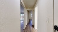 This 550-square-foot, one-bedroom, one-bathroom apartment at 500 Monroe Ave NE in Renton, Washington is a single-floor unit designed for efficient, comfortable living. Wood-style flooring runs continuously throughout the unit, providing a cohesive aesthetic across all rooms.

The living room serves as the focal point of the unit, featuring a tile-surround fireplace and a sliding glass door fitted with vertical blinds that opens to an outdoor patio area, allowing natural light and outdoor views into the space. A track light fixture overhead adds supplemental illumination.

The kitchen is designed with a peninsula layout, offering granite-style countertops, light wood cabinetry, a built-in sink, electric range, dishwasher, and a full-size refrigerator. A window above the counter provides additional natural light. The peninsula connects the kitchen to the living area, creating an open, functional flow.

The 140-square-foot primary bedroom features a baseboard heater, a window overlooking a green outdoor area, and access to two closets via a hallway, offering practical storage capacity.

The bathroom includes a full tub and shower combination, a wood-cabinet vanity with a granite-style countertop, a large mirror, and wood-style flooring consistent with the rest of the unit.