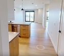 Located at 2310 Richmond Street in London, Ontario, this thoughtfully designed 1-bedroom, 1-bathroom unit offers 760 square feet of modern living space on a single floor. The open-concept kitchen and living area serves as the heart of the unit, featuring light hardwood flooring throughout, recessed lighting, and a seamless flow between spaces. The contemporary kitchen is equipped with stainless steel appliances, two-tone cabinetry combining white upper cabinets with warm wood lower units, a large peninsula island with a quartz countertop, matte black pendant lighting, and a black undermount sink. The spacious living room benefits from natural light and direct access to a private balcony through sliding glass doors, offering outdoor views of the surrounding neighbourhood. The 150 sq ft primary bedroom features a large window, a calming slate-blue accent wall, and light hardwood flooring. Two closets provide generous storage, including a walk-in closet with wire shelving systems. The bathroom is a standout, showcasing bold navy subway tile extending from the tub surround to the ceiling, paired with matte black fixtures and a clean white soaking tub. The unit's neutral palette and modern finishes create a cohesive, contemporary ambiance throughout.