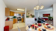 Located at 1583 Marc Dr in North Brunswick, NJ, this three-bedroom, three-bathroom townhome is thoughtfully distributed across three floors. The entry level features a garage and a welcoming entrance with a coat rack and staircase leading to the main living areas. The primary floor offers a bright, open-concept layout where the kitchen flows seamlessly into the dining and living areas. The kitchen is outfitted with warm wood cabinetry, granite countertops, stainless steel appliances including a gas range and built-in microwave, and tile flooring. The adjacent dining area is lit by a chandelier and benefits from a large window, while the spacious living room features neutral carpet and ample room for comfortable seating. The upper floor houses three bedrooms, including a generously sized primary bedroom, and is served by carpeted staircases with wood handrails. The bathrooms are finished with tile flooring, white vanities, large mirrors, and glass-enclosed showers. Additional highlights include five closets for plentiful storage, a dedicated laundry area, a balcony, and multiple hallways connecting each level. The overall aesthetic is clean and neutral, providing a functional and comfortable living environment.