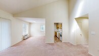 Located at 250 Treetops Drive in Highland Park, NJ, this one-bedroom, one-bathroom residence offers a well-organized and functional layout across a single floor. The living area immediately impresses with its notably tall ceilings, creating an open and airy atmosphere, complemented by soft wall-to-wall carpeting and a wall-mounted HVAC unit. Multiple windows invite generous natural light and offer views of surrounding greenery, enhancing the sense of space throughout.

The kitchen is efficiently designed with warm wood cabinetry, white appliances including an electric range and full-size refrigerator, ample counter space, and durable tile-style flooring. An adjacent area with additional cabinetry and countertop space provides extra utility and storage.

A carpeted hallway connects the living spaces to the private bedroom, which features two windows framing lush outdoor views, a wall HVAC unit, and a walk-in closet with a hanging rod for organized storage. The bathroom includes a full-size tub and shower combination with clean, white surrounds and chrome fixtures.

Additional storage is provided by closet space along the hallway, rounding out this practical and comfortable residence in a well-situated Highland Park location.