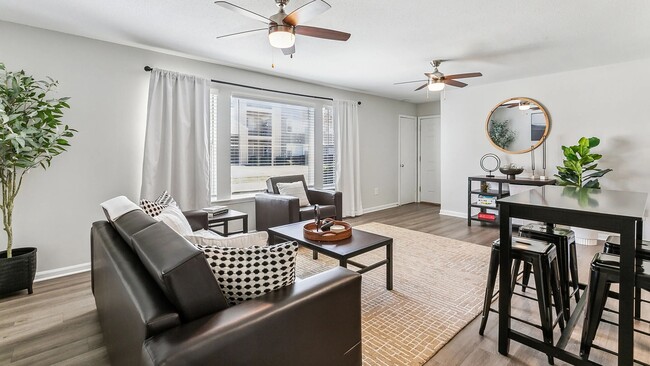 Our sun-soaked living room, fully furnished with dual multi-speed ceiling fans, invites you to unwind in style. A space that defines 'perfect'! - MAISON Burbank