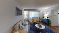 This single-floor residence offers a thoughtfully designed layout with multiple rooms connected by warm hardwood-style flooring that flows consistently throughout the space. The living room serves as a central gathering area, featuring neutral gray walls, a front-facing window dressed with sheer curtains that invite natural light, and ample room for comfortable seating arrangements. An ornamental wall piece adds a decorative focal point above the sofa.

The dining room is distinctly styled with rich dark hardwood flooring, a pendant light fixture overhead, and rustic floating wooden shelves mounted along one wall. It comfortably accommodates a full dining table setup, ideal for everyday meals or entertaining.

The kitchen is well-equipped with white shaker cabinetry, granite-style countertops, a classic subway tile backsplash, stainless steel appliances including a gas range and built-in microwave, and a window that brings in natural light.

The space includes multiple bedrooms, each finished with hardwood-style flooring and neutral walls. One bedroom features a double closet with built-in shelving, while another offers window views and generous floor space. The full bathroom includes a tub-shower combination, a window for ventilation, and a granite-topped vanity with white cabinetry.