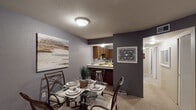 Located at 4252 Alpenhorn Dr NW in Comstock Park, Michigan, this single-floor residence offers a well-designed layout with a cohesive, contemporary color palette of cool grays and neutral tones throughout. The living room serves as a welcoming focal point, anchored by a bold dark accent wall, plush carpeting, and a front entry that flows naturally into the rest of the home. Adjacent to the living area, the dedicated dining space comfortably accommodates a full dining set and connects seamlessly to the kitchen via a pass-through breakfast bar with bar seating. The kitchen is well-equipped, featuring rich dark wood cabinetry, ample counter space, a double-basin sink, and a dishwasher, making it both practical and functional. A hallway leads to two carpeted bedrooms, each benefiting from natural light through window treatments and offering generous space. The primary bedroom features a bold gray accent wall, while the second bedroom enjoys bright, sheer-curtained windows. The full bathroom is finished with a wood-toned vanity, white countertop, tiled tub-shower combination, and gray walls that complement the overall design theme. Throughout the residence, consistent flooring, neutral carpeting, and a unified color scheme create a cohesive and inviting atmosphere.