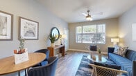 This efficient and thoughtfully designed one-bedroom, one-bathroom residence offers a functional single-floor layout that maximizes every square foot. The open-concept living and dining area is anchored by warm wood-look flooring, neutral gray walls, and a ceiling fan overhead. A large window floods the space with natural light and provides outdoor views, creating an airy and inviting atmosphere throughout.

The kitchen features white cabinetry, a light quartz countertop with a breakfast bar peninsula, and a full suite of stainless steel appliances, including a refrigerator, electric range, built-in microwave, and dishwasher. An adjacent closet houses in-unit laundry, adding significant everyday convenience.

The bedroom is a comfortable, well-proportioned retreat with vertical blinds covering a generous window that brings in additional natural light. The full bathroom is finished with wood-look tile flooring, a white vanity with ample counter space, and a tub-shower combination adorned with large-format marble-style tile surround. A dedicated closet provides practical storage. The hallway connects all rooms cohesively, completing a layout that is both practical and comfortable.