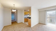 Located at 7669 Marcin Drive in Glen Burnie, Maryland, this 2-bedroom, 1-bathroom home offers a practical and well-organized single-floor layout. The space is thoughtfully arranged to maximize functionality across its rooms.

The galley-style kitchen is a standout feature, lined with warm honey-toned wood cabinetry on both sides, offering generous storage and counter space. It is equipped with a gas range, stainless steel refrigerator, and a light-filled window above the sink area, all set atop elegant tile flooring.

Both bedrooms are finished with neutral wall-to-wall carpeting that adds warmth and comfort underfoot. The primary bedroom is a well-proportioned space, featuring a large double-door closet for ample storage. The second bedroom benefits from a multi-pane window that allows natural light to filter in, creating a bright and airy atmosphere. A spacious living area with soft carpeting and a welcoming entry door rounds out the main living space.

The bathroom is clean and complete, featuring a full tub and shower combination, a toilet, and a wood-toned vanity with mirror, complemented by tile flooring and a window for natural ventilation.

A connecting hallway ties the rooms together, providing a smooth flow throughout the home. The overall aesthetic is clean, neutral, and move-in ready.