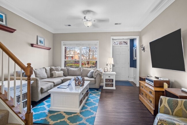 Photo - This inviting two-level townhome offers comfort and style, featuring gleaming hardwood floors on ...