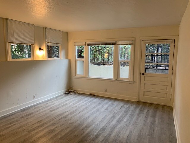 Living room facing front door and front window. - 24606 University Ave