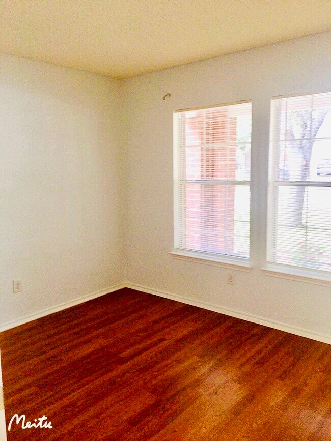 1st bedroom with big windows facing to front deck with a yard view - 1904 Carriage Club Dr