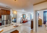 Located at 820 N Campbell Station Rd in Farragut, Tennessee, this single-story residence offers a thoughtfully designed layout with a cohesive, modern aesthetic throughout. The open-concept kitchen serves as a central hub, showcasing granite countertops, rich dark wood cabinetry, stainless steel appliances, and a peninsula with an undermount double sink. Stylish pendant lights hang overhead, complementing the track lighting and light wood-style flooring that extends into the adjoining living area.

The living room is generously proportioned, featuring a ceiling fan, large windows dressed with draping curtains that invite natural light, and wood-toned accent furniture lending a warm, inviting atmosphere. Multiple bedrooms provide comfortable retreats, each with plush carpeting, ample closet space, and large windows. One bedroom includes a ceiling fan and direct access to a private bathroom.

The bathrooms are finished with wood-look tile flooring, dark cabinetry with granite countertops, illuminated mirrors, and tub-shower combinations featuring wood-grain tile surrounds. The overall ambiance throughout the residence is clean, contemporary, and well-balanced, blending functional design with warm, inviting finishes.