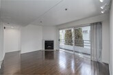 Located in the heart of Westwood, Los Angeles, this well-appointed 3-bedroom, 2-bathroom residence offers a practical and comfortable single-floor layout. The open-plan living and kitchen area serves as the central hub of the home, featuring rich hardwood flooring, a classic fireplace with a white surround, and sliding glass doors that lead to a private balcony with views of mature trees — filling the space with natural light and a connection to the outdoors.

The kitchen is efficiently designed with white cabinetry, a pass-through counter, light tile flooring, and black appliances including a gas range and over-the-range microwave, providing everything needed for everyday cooking.

The primary bedroom is generously sized and includes large sliding glass doors opening directly to the balcony, track lighting, and hardwood floors. The two additional bedrooms feature soft carpeting and windows with views of surrounding greenery, offering comfortable and bright spaces.

Both bathrooms are finished with light tile flooring, white vanities, and enclosed shower-tub combinations with sliding glass doors. The clean, neutral palette throughout the residence creates a bright and cohesive atmosphere, making this Westwood home a versatile and inviting space.