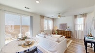 Located at 2800 N Bonnie Brae St in Denton, TX, this two-story, 2-bedroom, 3-bathroom home offers a well-designed layout spread across two floors. The main level hosts the open-concept kitchen and living area, a full bathroom, laundry, and staircase access. The kitchen is a standout feature, showcasing two-tone cabinetry with crisp white uppers and deep navy lowers, granite countertops, a subway tile backsplash, stainless steel appliances, and a center island with bar seating — all complemented by light hardwood-style flooring. The living room flows naturally from the kitchen, bathed in natural light from multiple windows with sheer linen curtains, and features a ceiling fan and direct access to an outdoor area. A compact, clean powder bathroom with a pedestal sink rounds out the main level. Upstairs, two carpeted bedrooms each include a ceiling fan and a dedicated walk-in closet. The generously sized primary bedroom offers comfortable proportions and ample storage. Two additional full bathrooms serve the upper floor, one featuring a glass-enclosed walk-in shower with a window for natural light. A hallway connects the upper-level rooms, completing this efficiently designed and thoughtfully appointed home.