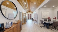 Located at 3314 S Old Missouri Rd in Springdale, Arkansas, this single-story community clubhouse is thoughtfully designed to offer residents a variety of amenity spaces under one roof. The entrance greets visitors with a dramatic vaulted ceiling clad in warm wood planking, recessed lighting, and light wood-look flooring that flows throughout — immediately establishing a welcoming and refined atmosphere.

The central gathering area features an open-concept layout connecting a comfortable lounge with seating arrangements and an adjacent dining space. Abundant natural light pours in through multiple windows dressed with white blinds, while ceiling fans and crown molding add to the polished finish. A built-in workstation with computers makes the dining area multifunctional, ideal for both community meetings and casual use.

A compact kitchenette serves the space with granite countertops, dark cabinetry, a full-size refrigerator, microwave, and dishwasher — well-suited for hosting events.

The media room offers a cozy, intimate retreat with a bold dark color palette, a large flat-screen television, leather recliner seating, and stylish gold-accented cabinetry, creating a true theater-like experience.

The fitness center spans two connected rooms, comprehensively equipped with treadmills, ellipticals, stationary bikes with interactive screens, a multi-station cable machine, and a full array of free weights and medicine balls, all brightened by natural light and wall-mounted televisions.