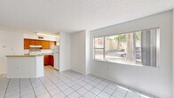 Located at 2271 Weston Ln in Orlando, FL, this single-floor, 3-bedroom, 2-bathroom home offers a functional and straightforward layout designed for comfortable everyday living. The open-concept living and kitchen area forms the heart of the home, featuring white ceramic tile flooring and a textured ceiling throughout. The kitchen is equipped with warm-toned wood cabinetry, a granite-style laminate peninsula countertop, white appliances including a refrigerator and electric range, and a tile backsplash. A large window in the living area fills the space with natural light and provides views of the surrounding neighborhood. A hallway connects the main living area to the three bedrooms, each featuring soft carpeted flooring, windows for natural light, and louvered bifold closet doors offering ample storage. The primary bedroom provides a comfortable and well-proportioned retreat. The two bathrooms are finished with white tile flooring and include shower-tub combinations and wood-toned vanity cabinetry. A dedicated hallway closet adds additional storage convenience. The clean, neutral color palette and consistent finishes throughout create a cohesive and move-in-ready environment.