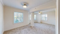 Located on West Franklin Street in Richmond, Virginia, this well-appointed 2-bedroom, 2-bathroom single-floor residence offers a thoughtfully designed layout across a comfortable footprint. The open living area is defined by soft neutral carpeting, crown molding, and structural columns that subtly delineate spaces while preserving an airy, connected feel. Multiple windows flood the living room with natural light, and a ceiling fan adds both function and character to the space.

The kitchen features warm honey-toned cabinetry, dark granite countertops, stainless steel appliances, and a curved breakfast bar that opens toward the living area — ideal for casual dining or entertaining. Tile flooring runs throughout the kitchen and hallway, while carpet continues through the living spaces and bedrooms.

The spacious primary bedroom includes a ceiling fan, closet access, and direct entry to a generous en-suite bathroom appointed with a soaking tub framed by dual windows, a separate glass-enclosed shower, and tile flooring. The second bedroom also features a ceiling fan and a closet. The second bathroom offers a tiled tub/shower combo, a vanity with wood cabinetry, and tile floors. A hallway connects all rooms, completing this functional and comfortable single-floor layout.