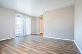 Located at 6526 Raymond Rd in Madison, Wisconsin, this single-floor unit offers a practical and efficiently designed layout. The space is finished with durable wood-look vinyl plank flooring throughout, lending a cohesive and clean aesthetic from room to room.

The living area is bright and open, featuring neutral gray walls, a large sliding glass door with vertical blinds that allows ample natural light and outdoor views, and an additional window for cross ventilation. A wall-mounted air conditioning unit and baseboard heating provide year-round climate control.

The kitchen is tucked adjacent to the living space and is equipped with warm wood-toned cabinetry, a sink, and functional counter space — offering everything needed for everyday meal preparation.

A dedicated closet provides convenient storage, while the full bathroom is cleanly finished with light vinyl flooring, a wood-toned vanity with a white countertop, a toilet, and a full tub-shower combination with a curved curtain rod and white surround.

The unit's neutral color palette, consistent flooring, and practical layout make it a straightforward, move-in-ready space suitable for those seeking an efficient and comfortable living environment in Madison, WI.