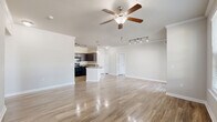 Located at 5525 Mansions Bluffs in San Antonio, TX, this well-appointed single-story, 3-bedroom, 2-bathroom home offers a thoughtfully designed open-concept layout. Wood-look flooring flows throughout the entire residence, complemented by neutral-toned walls and crown molding that add a polished touch to the living spaces.

The spacious living room is bathed in natural light from large windows and a sliding glass door that opens to a private patio, offering pleasant outdoor views. A ceiling fan and track lighting provide both comfort and ambiance. The kitchen features dark espresso cabinetry, granite-style countertops, black appliances, and a pantry for added storage, seamlessly connecting to the living area.

The primary bedroom is generously sized, with a ceiling fan, crown molding, and direct access to a private bathroom. The en-suite bath includes a dark vanity with granite countertops and a tiled shower-tub combination. Additional bedrooms offer walk-in closets and windows with outdoor views. A dedicated laundry room with washer and dryer hookups adds everyday convenience. With four closets total and a hallway connecting the private quarters, this home delivers a practical and comfortable floor plan throughout.