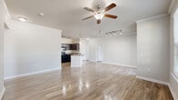 Located at 5525 Mansions Bluffs in San Antonio, TX, this well-appointed single-story, 3-bedroom, 2-bathroom home offers a thoughtfully designed open-concept layout. Wood-look flooring flows throughout the entire residence, complemented by neutral-toned walls and crown molding that add a polished touch to the living spaces.

The spacious living room is bathed in natural light from large windows and a sliding glass door that opens to a private patio, offering pleasant outdoor views. A ceiling fan and track lighting provide both comfort and ambiance. The kitchen features dark espresso cabinetry, granite-style countertops, black appliances, and a pantry for added storage, seamlessly connecting to the living area.

The primary bedroom is generously sized, with a ceiling fan, crown molding, and direct access to a private bathroom. The en-suite bath includes a dark vanity with granite countertops and a tiled shower-tub combination. Additional bedrooms offer walk-in closets and windows with outdoor views. A dedicated laundry room with washer and dryer hookups adds everyday convenience. With four closets total and a hallway connecting the private quarters, this home delivers a practical and comfortable floor plan throughout.